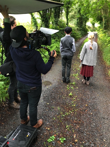 Crew films young actors walking down country road in Ireland 1-1