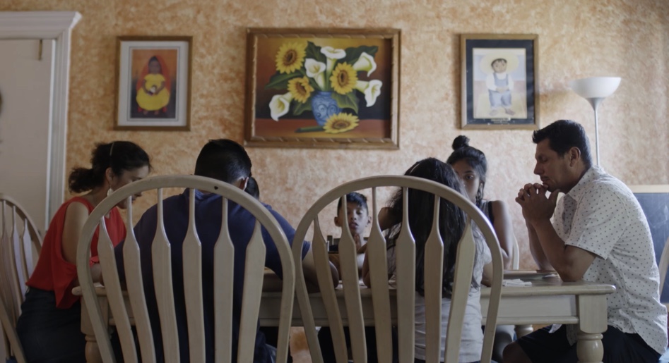 Vazquez Family praying at the dinner table